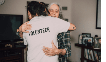 Volunteer giving a hug