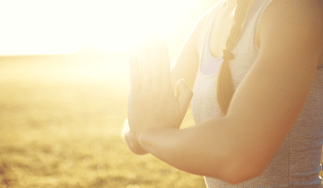 Lighting shining on women meditating 