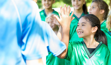 Young girl giving a high-five